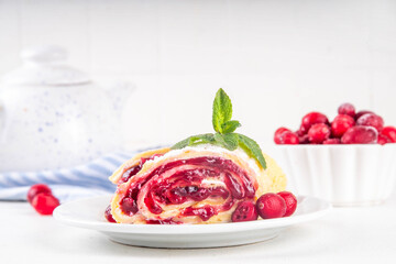 Cranberry strudel, winter rolled dessert cake with cranberry jam