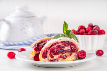 Cranberry strudel, winter rolled dessert cake with cranberry jam