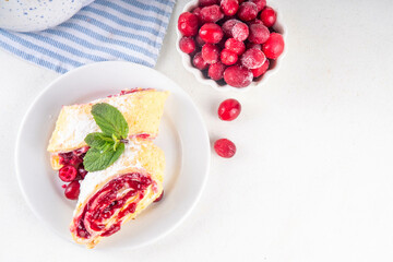 Cranberry strudel, winter rolled dessert cake with cranberry jam
