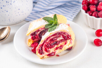 Cranberry strudel, winter rolled dessert cake with cranberry jam