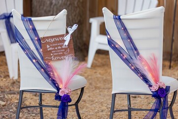 Elegant wedding chairs with memorial sign.