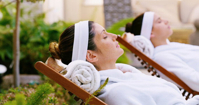 Resort, woman and relax in robe by spa for weekend break, stress relief or luxury treatment outdoor. Friends, person and resting at beauty lodge for wellness, comfort and self care on holiday getaway