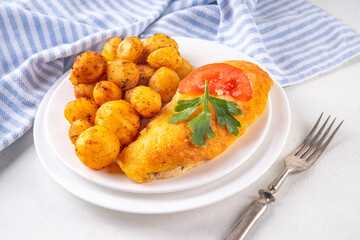 Breaded chicken cutlet with whole fried baby potato side