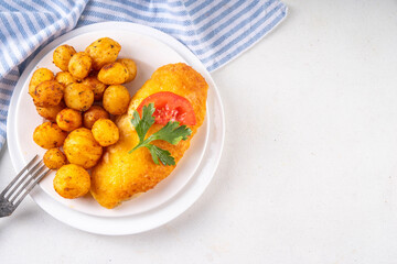 Breaded chicken cutlet with whole fried baby potato side