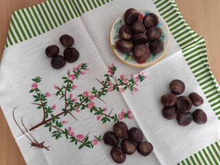 Shiny brown chestnuts on the table