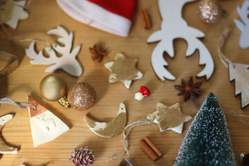 Various Christmas decorations in neutral colors on wooden background. Selective focus.
