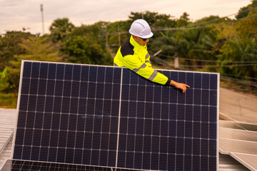 technician lifting a photovoltaic panel during installation, showcasing renewable energy advancement. Dressed in safety gear, reflecting a focus on green energy solutions and sustainable development.