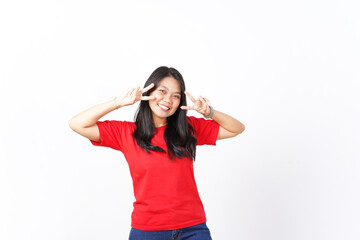 Fototapeta premium Showing Peace Sign or Victory sign Of Beautiful Asian Woman wearing red shirt Isolated On White Background