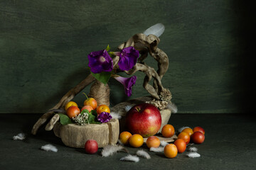 design, composition, ikebana, still life of summer wildflowers, tree roots, apples, plums, bird feathers, Ipomeia flowers