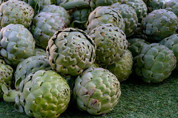 Fresh ripe green organic artichokes heads on local farmers market in Dordogne, France