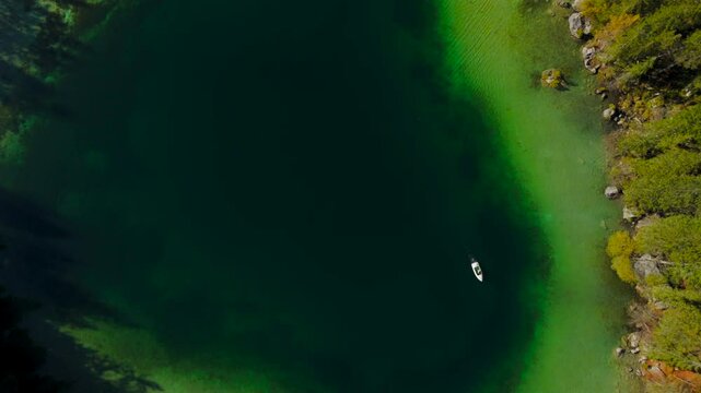 Hintersee in Ramsau, Germany, captured from above in autumn, reveals turquoise waters, majestic Alps, and enchanting Magic Forest. Explore this serene lake with boat rentals, perfect for relaxation. 