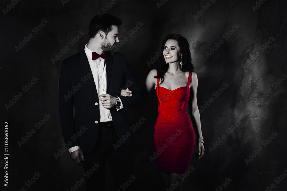 Poster portrait of pretty charming lady in violet dress holding under hand with virile bearded man in tuxed
