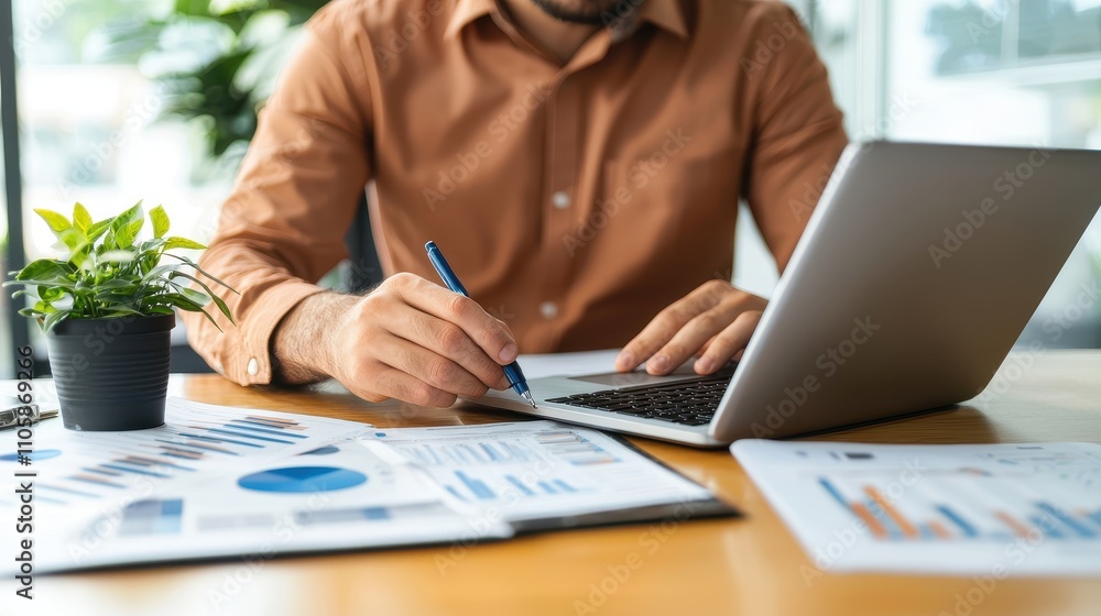 Poster businessman analyzing data and working on laptop in office setting