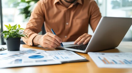 Businessman Analyzing Data and Working on Laptop in Office Setting
