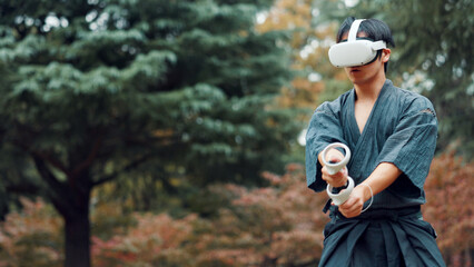 Virtual reality, controller and Asian man with technology for martial arts, Kendo practice and exercise. Culture, Japan and person with shinai, VR goggles and metaverse for skill, fight and training