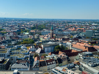 Fototapeta premium Beautiful aerial footage of Marienplatz the magestic New Town Hall, its clock and the Frauenkirche gothic church in the City of Munich Babaria Germany
