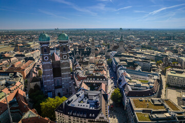 Fototapeta premium Beautiful aerial footage of Marienplatz the magestic New Town Hall, its clock and the Frauenkirche gothic church in the City of Munich Babaria Germany