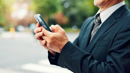 Outdoor, hands and businessman with smartphone on internet for city navigation and directions in Japan. Male person, employee and community in downtown Tokyo with online map for location and address