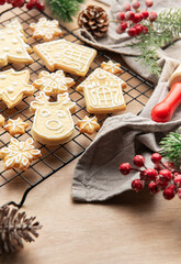 Christmas cookies cooling on rack with festive decorations and rolling pin