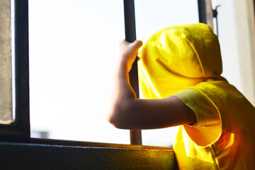 Little kid looking through the window.