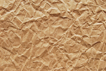 A sheet of brown kraft recycled wrinkled paper texture as background