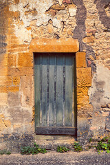 Sunbleached old green door in a sleepy French village.