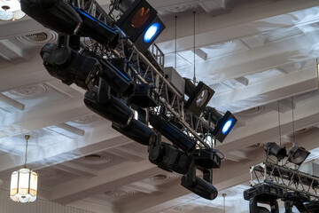 Advanced lighting fixtures are strategically arranged above a spacious venue, showcasing a...