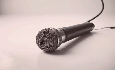 Microphone is on a white background. The microphone is black and silver