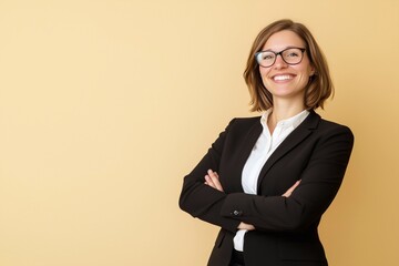 A happy middle-aged 40s professional business woman executive leader with arms crossed isolated on beige background.