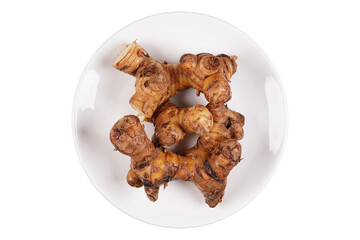 Galangal root on a white plate isolated transparent