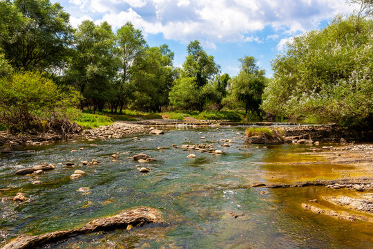 Sunny August view of the shallow waters of Vidima River in the Bulgarian Fore-Balkan village of Debnevo, Troyan Municipality
