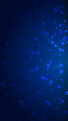 Blue 3d balls with light rays at the right on a dark background, vertical composition. Event and banner background.