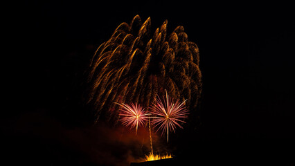 Beautiful and bright fireworks in the night sky above the city