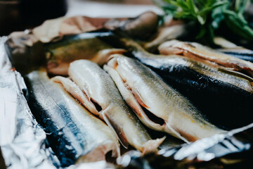Raw fish before cooking in the kitchen. Preparing trout for baking in a roasting pan. Cooking in the home kitchen, fish for holidays, fish dishes.