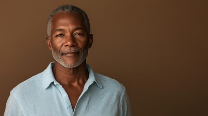 Experienced African American man in his 60s with short gray hair and calm expression against a warm brown background