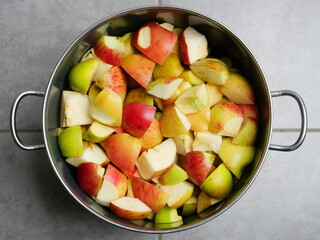 Apples, cut into pieces - Pot full of sliced ​​apples being prepared for making applesauce.