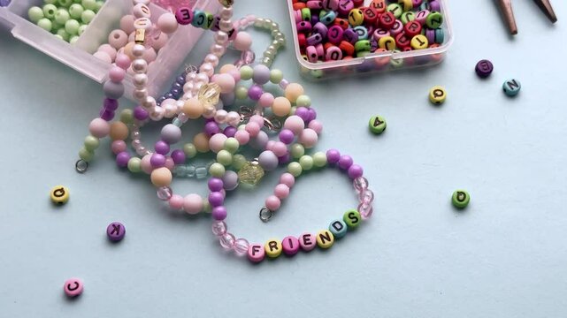 Crafting colorful bracelets with beads and tools on a table
