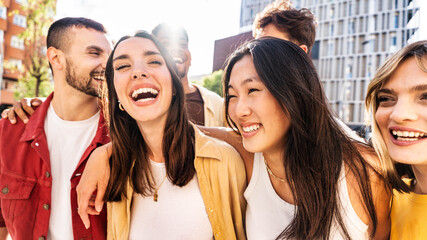 Multiethnic friends having fun walking on city street - Group of young people enjoying summer vacation together - Friendship concept with guys and girls hanging outside on a sunny day