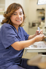 Smiling dental technician working in a laboratory