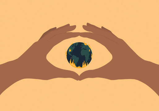 Hands forming eye shaped frame for burning planet earth