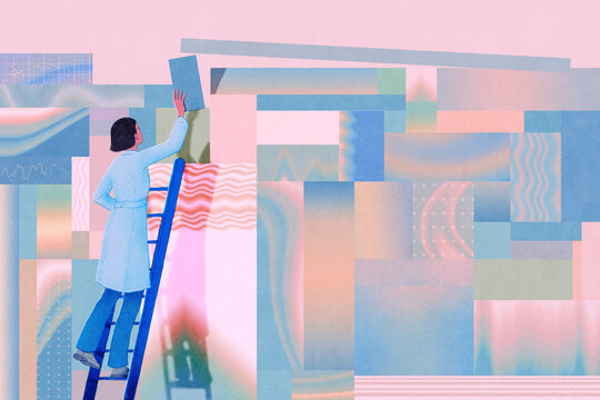 Scientist on ladder building wall with different blocks