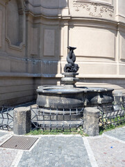 Fountain with Three Entangled Dolphin Bodies at St. Nicholas Church in the Old Town Square, Prague, Czech Republic
