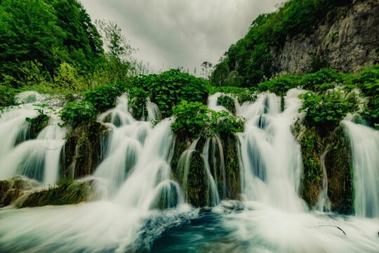 Serene waterfall in lush forest - Powered by Adobe