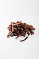 A natural chewy treat for dogs on a white background. The concept of selling healthy treats for pets of all breeds and ages. Photo of a dried 