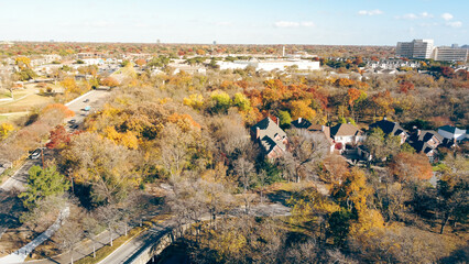 Urban sprawl with suburban park and residential neighborhood surrounding by beautiful fall foliage...