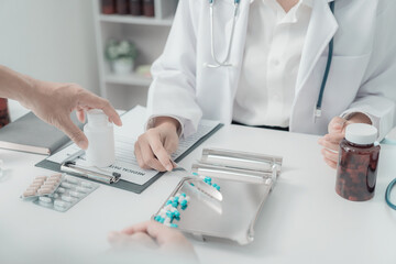 medical concept Healthcare and people. Female doctor with tablet PC talking to patient, giving advice during health checkup in clinic.