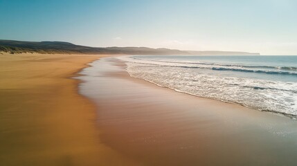 Obraz premium Serene beach landscape featuring pristine sand gentle waves calm ocean scenic tropical destination capturing pure natural beauty
