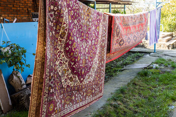 old woolen carpets dry on clotheslines