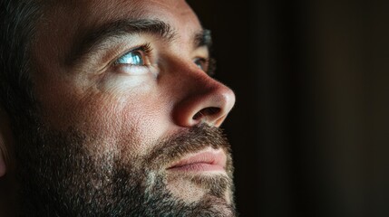 Fototapeta premium A close-up profile shot of a man with a thoughtful expression, emphasizing contemplation
