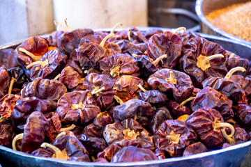 Dried chilies displayed in metal bowl in spice market